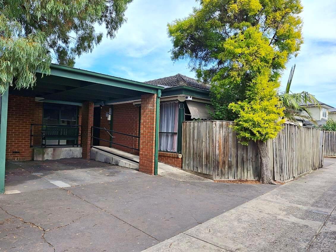 Front of a one story red brick home