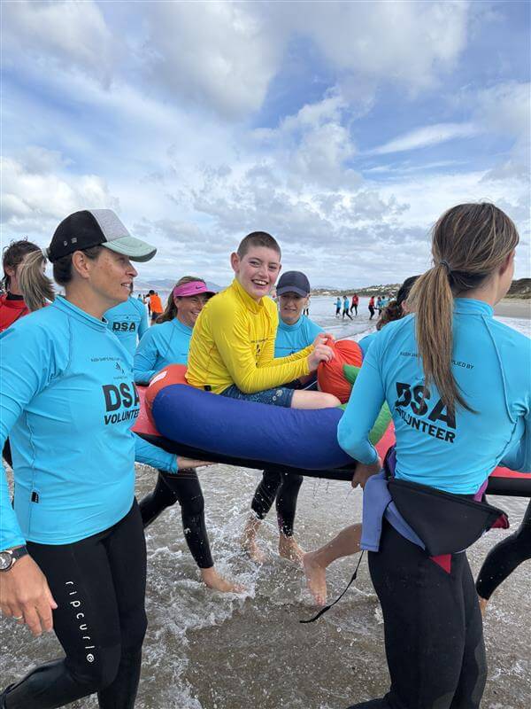 Cody on the surf board after his first time hitting the waves