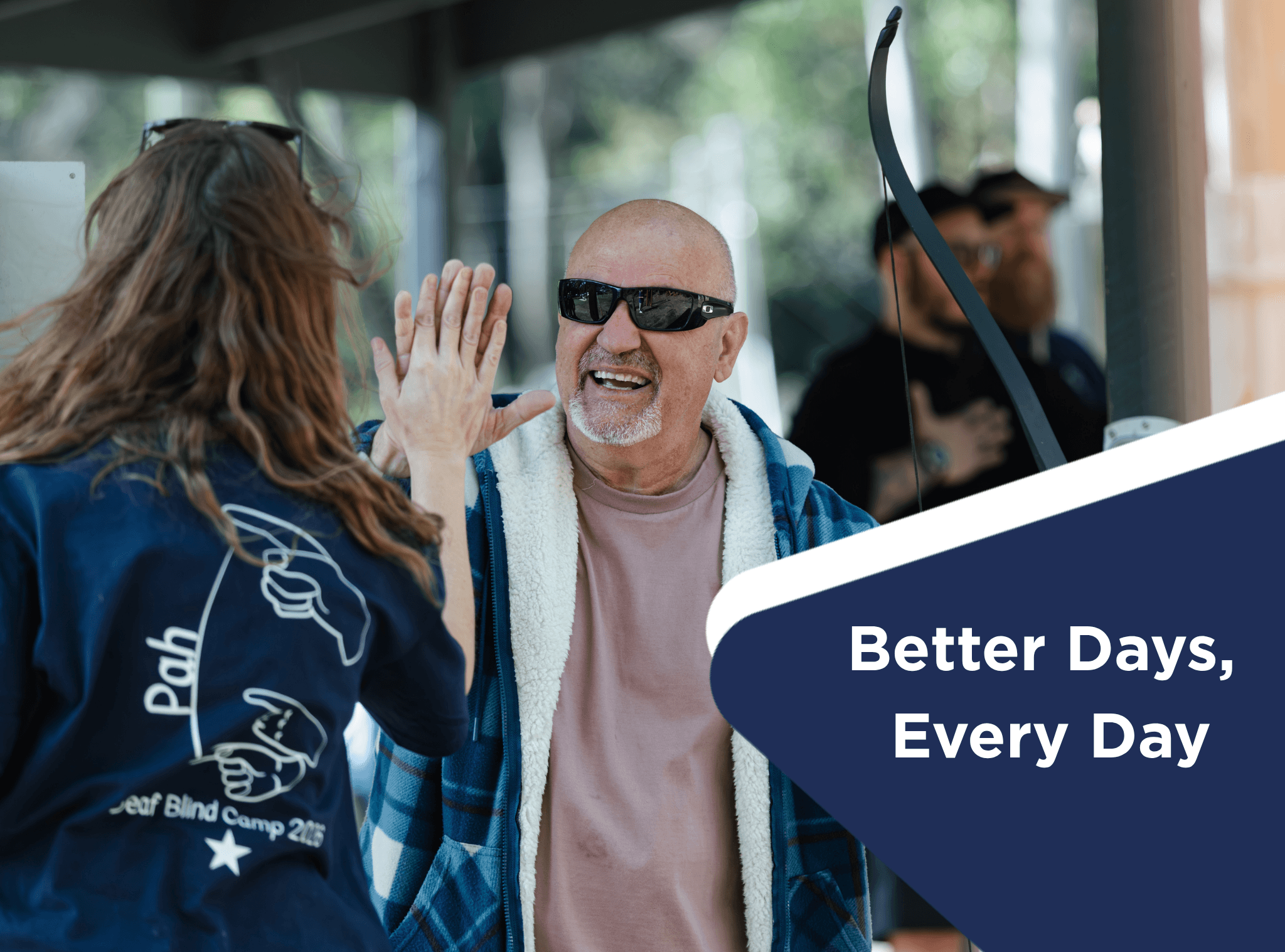 Two people high fiving eachother. There is a caption that says Better Days, Every Day.
