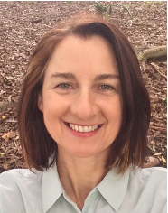 A photo of Lauri. She has a bob haircut with brown hair and is smiling at the camera.