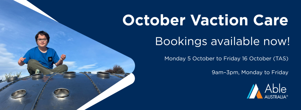 A person wearing a blue T-shirt and glasses sits on top of a large blue playground structure outdoors under a bright blue sky with scattered clouds. The image is positioned on the left side of a promotional banner. On the right side, white text on a dark blue background reads: "October Vacation Care", "Bookings available now!", "Monday 5 October to Friday 16 October", and "9am–3pm, Monday to Friday". The Able Australia logo appears in the bottom right corner. White graphic shapes frame the photograph and separate it from the text.